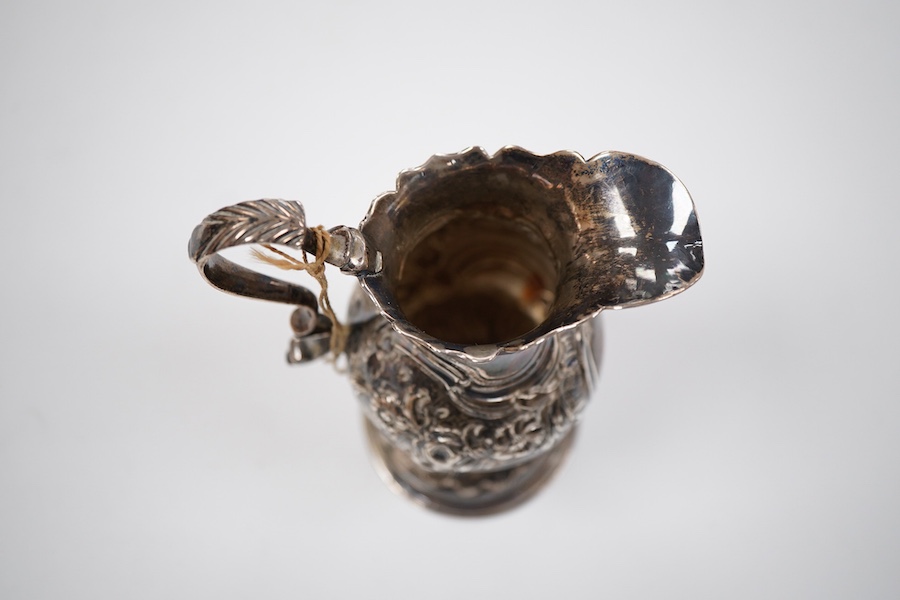 A George III silver inverted pyriform cream jug, with later embossed decoration, Charles Chesterman II, London, 1779?, height 11.4cm.